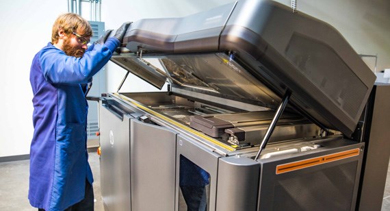 multijet fusion technician examining 3D parts