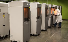 technician examining 3d printed parts in Brazil Metal Parts 3D printers